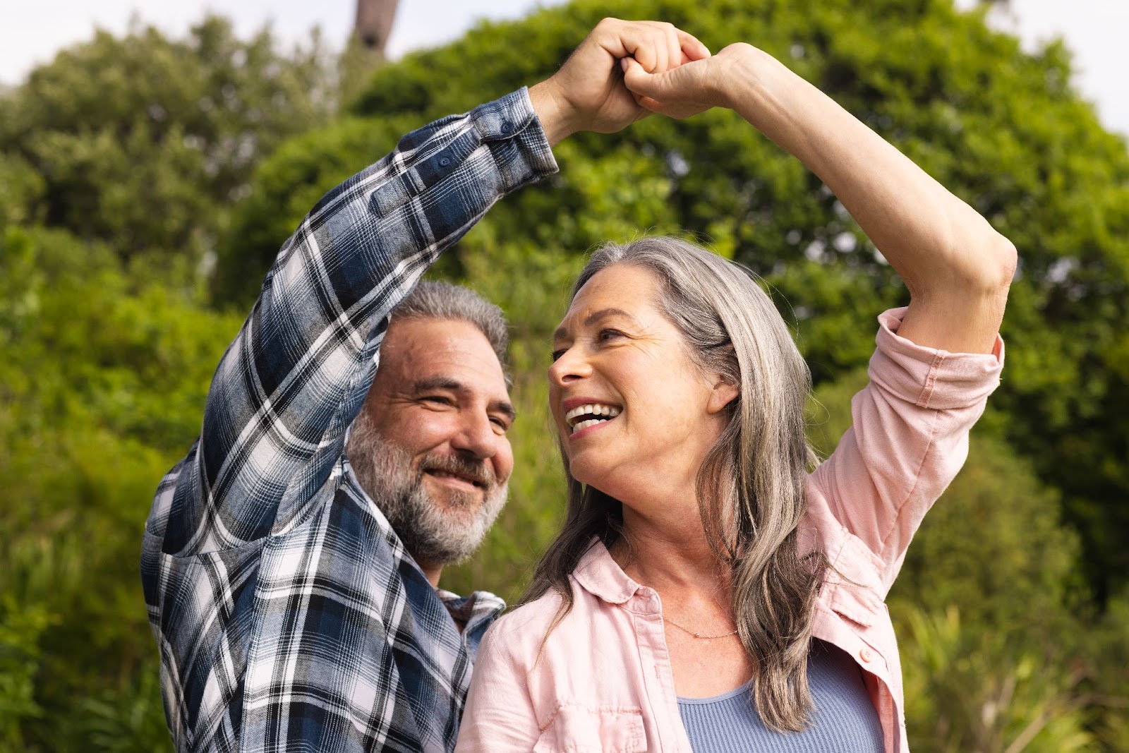 Middle aged couple dancing outside