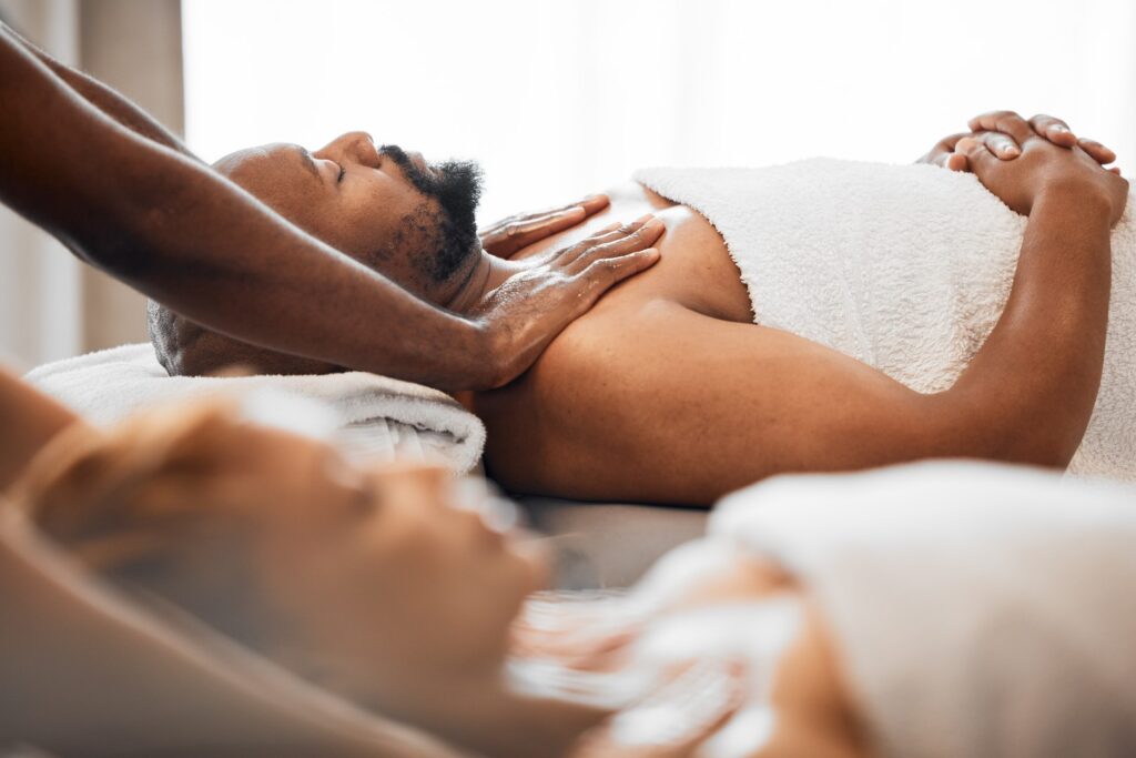 man receiving shoulder massage on table