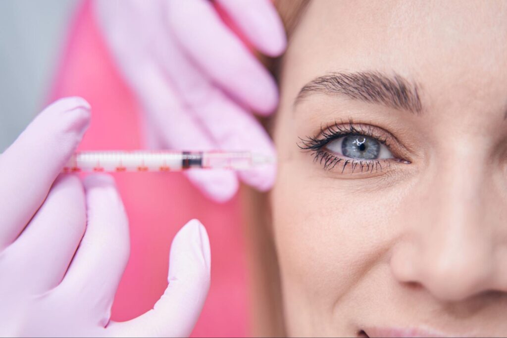 closeup of woman getting Botox injection around eyes