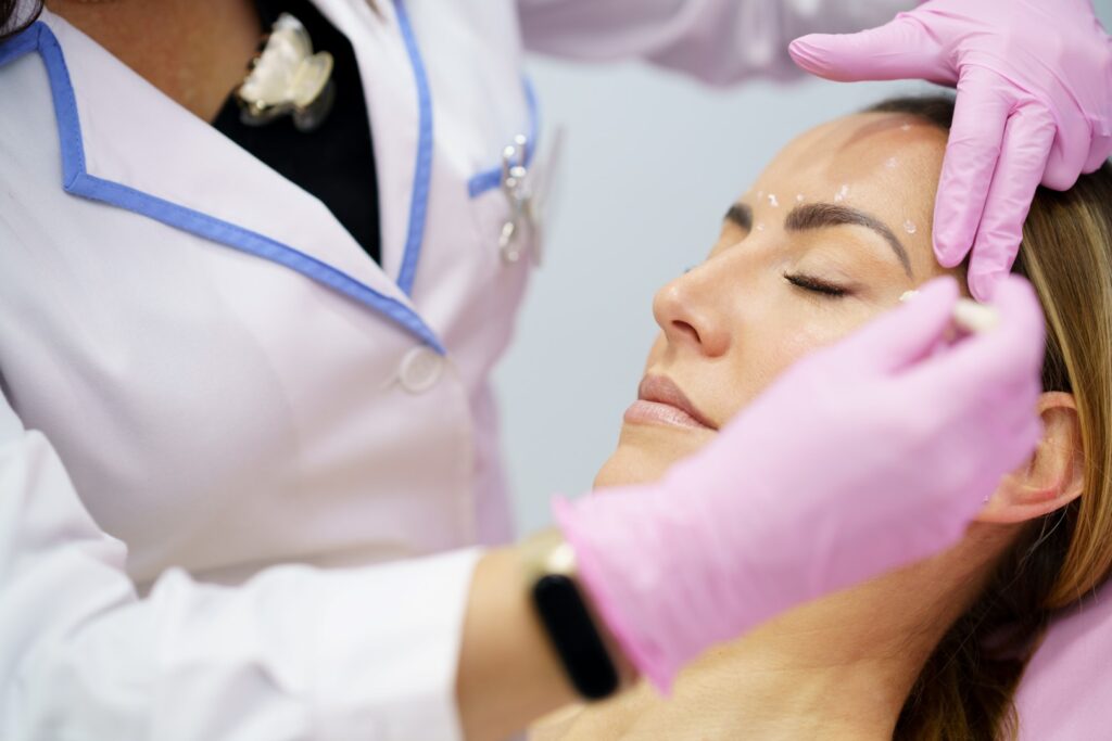 practitioner doing treatment on woman's face
