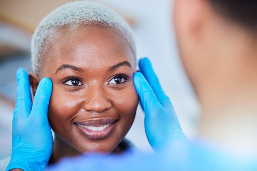 Practitioner examining the results of woman's Botox
