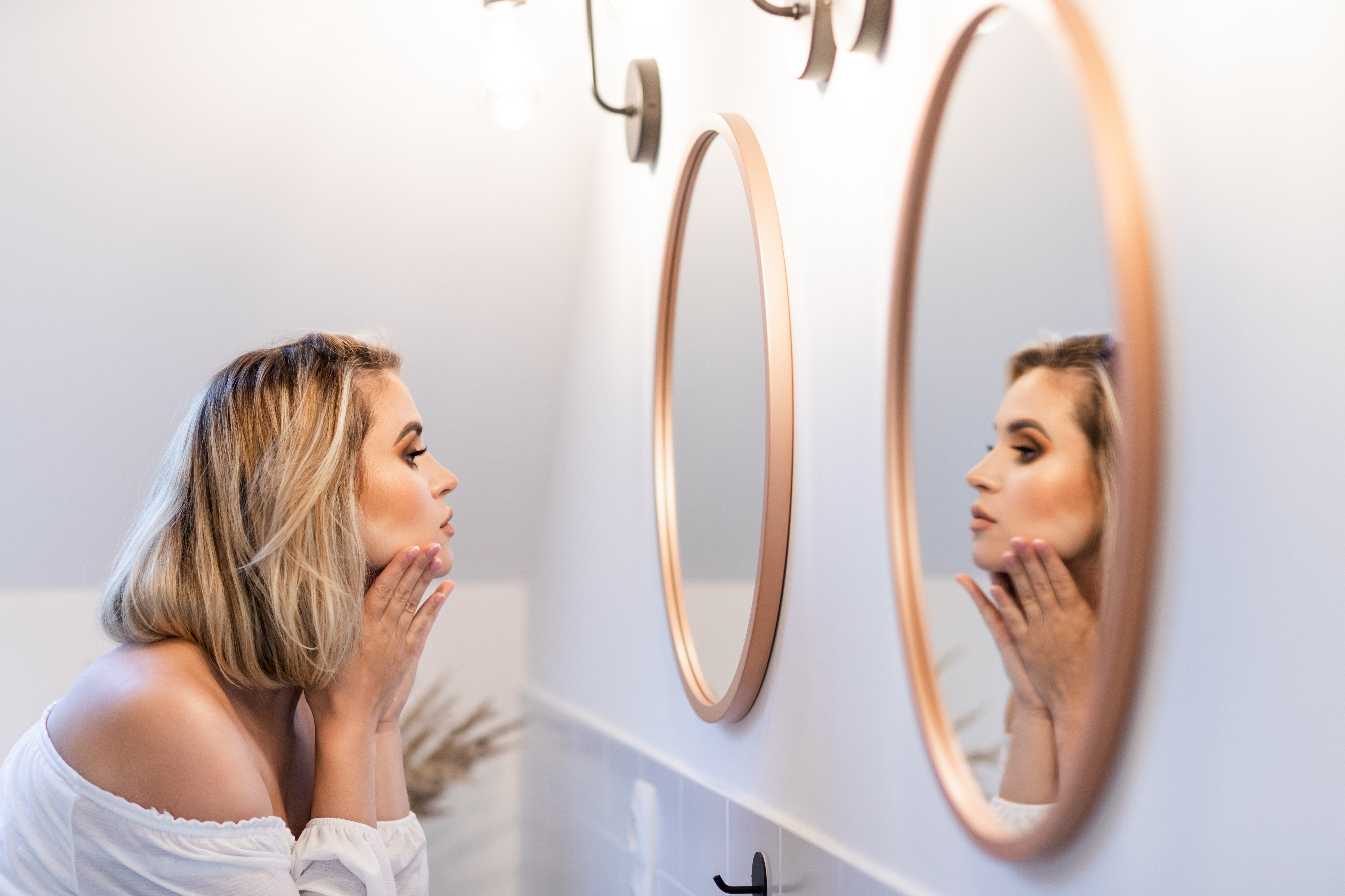 woman looking in mirror